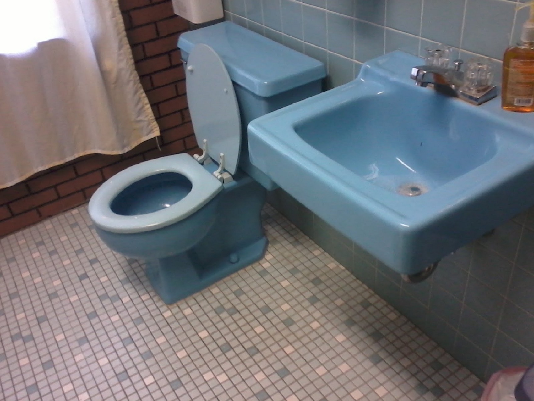 blue color toilet furnishing a vintage style bathroom