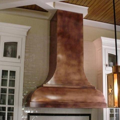 48 inch wide copper range hood in a kitchen with built-in extractor insert