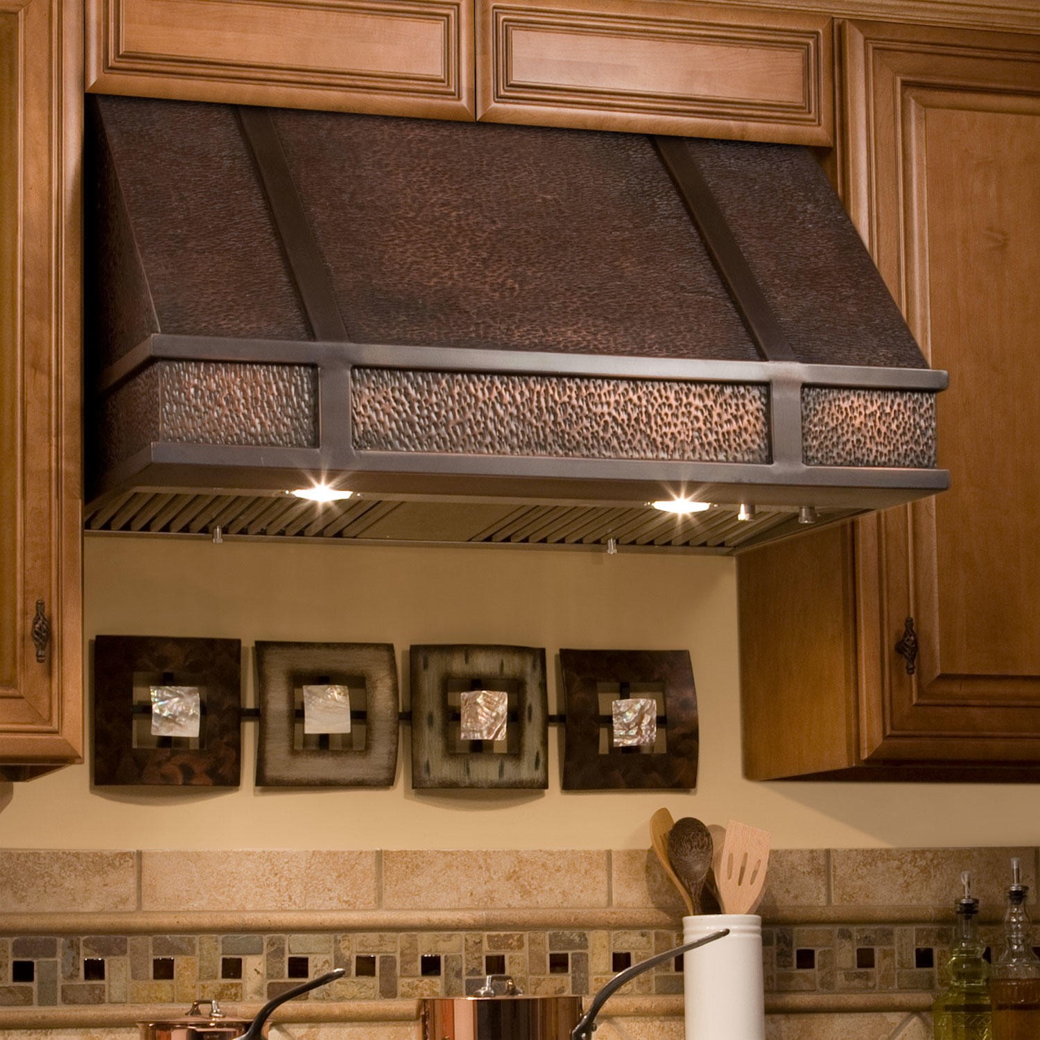 distressed metal copper stove hood installed on a wall of kitchen