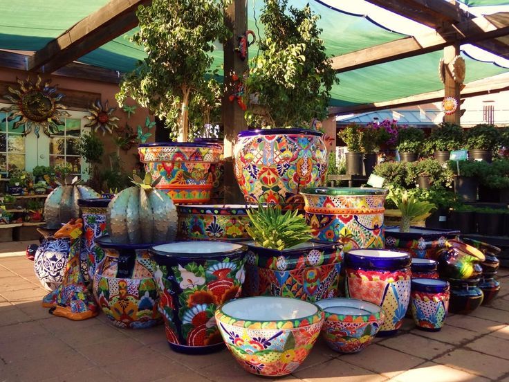 Mexican hand painted pottery decorating a garden backyard