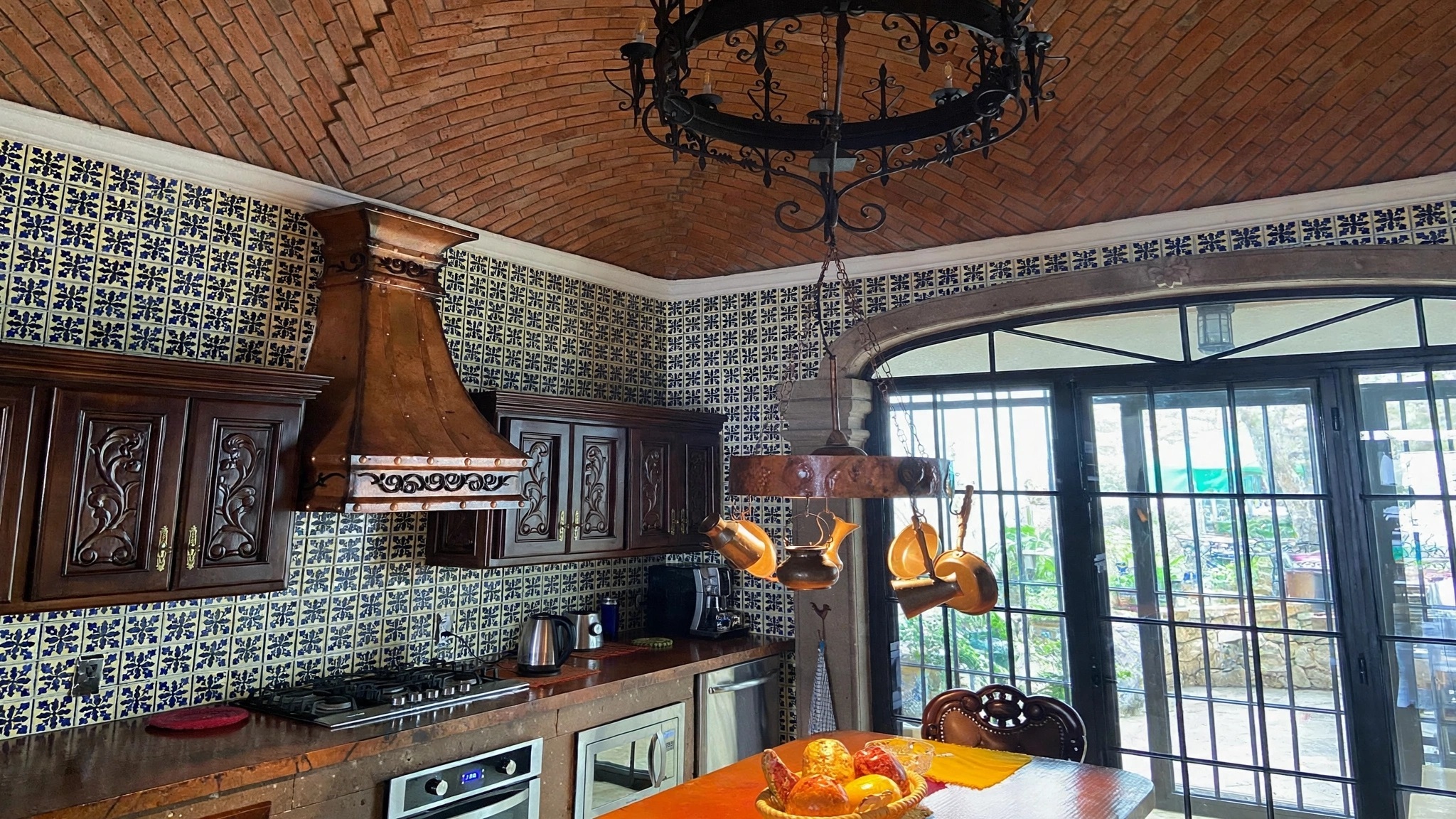 Spanish style copper range hood in a kitchen
