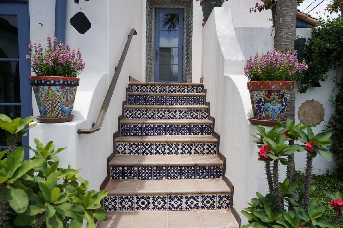 mexican tiles installed on a stair risers outside of the house