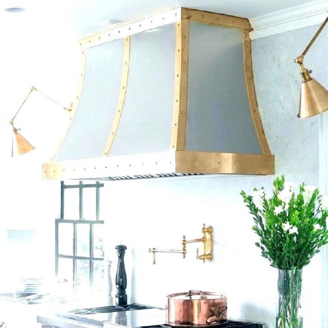 wall mount brass range hood in a kitchen
